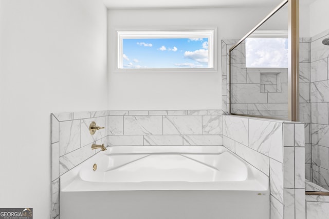 bathroom featuring separate shower and tub