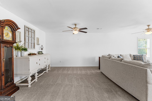 living room with ceiling fan and light carpet