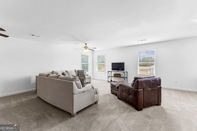 living room featuring light colored carpet and ceiling fan