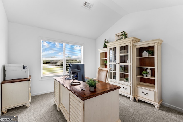 carpeted office space with vaulted ceiling