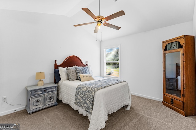 bedroom with ceiling fan, light colored carpet, and vaulted ceiling