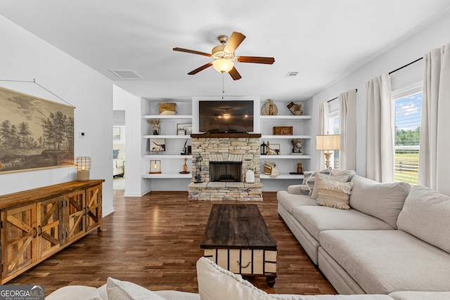 living room with a fireplace, dark hardwood / wood-style flooring, built in features, and ceiling fan