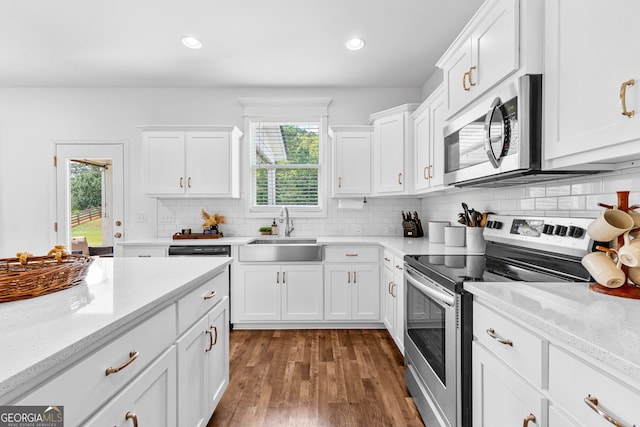 kitchen featuring dark wood-type flooring, appliances with stainless steel finishes, plenty of natural light, and sink