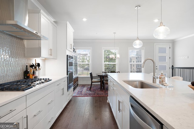 kitchen featuring white cabinets, hanging light fixtures, wall chimney range hood, stainless steel appliances, and dark hardwood / wood-style flooring