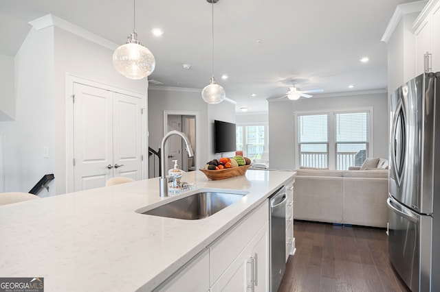 kitchen with light stone counters, white cabinets, stainless steel appliances, dark hardwood / wood-style floors, and sink