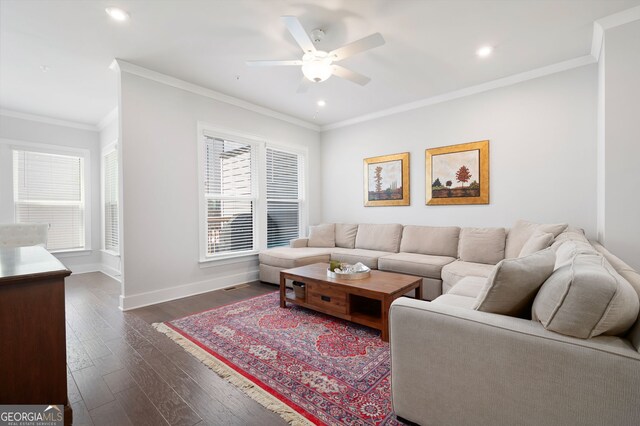 living room featuring ceiling fan, crown molding, dark hardwood / wood-style flooring, and a healthy amount of sunlight