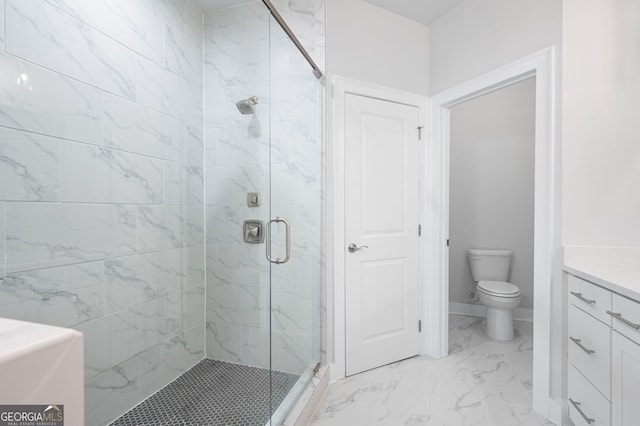 bathroom with vanity, a shower with shower door, and toilet