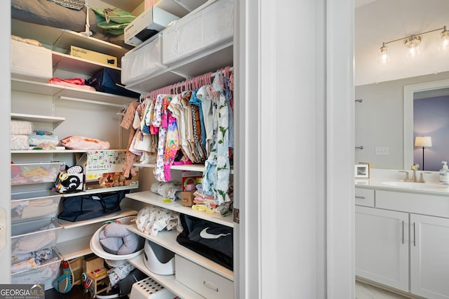 spacious closet featuring sink