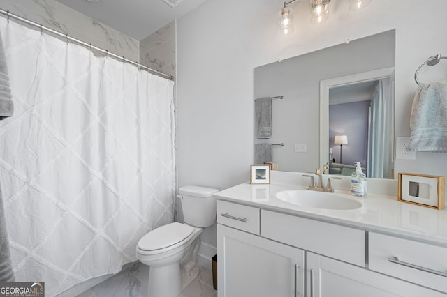 bathroom featuring vanity and toilet