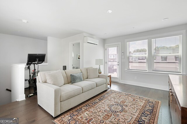 living room featuring dark hardwood / wood-style floors and a wall mounted air conditioner