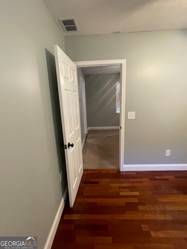 corridor featuring dark hardwood / wood-style floors