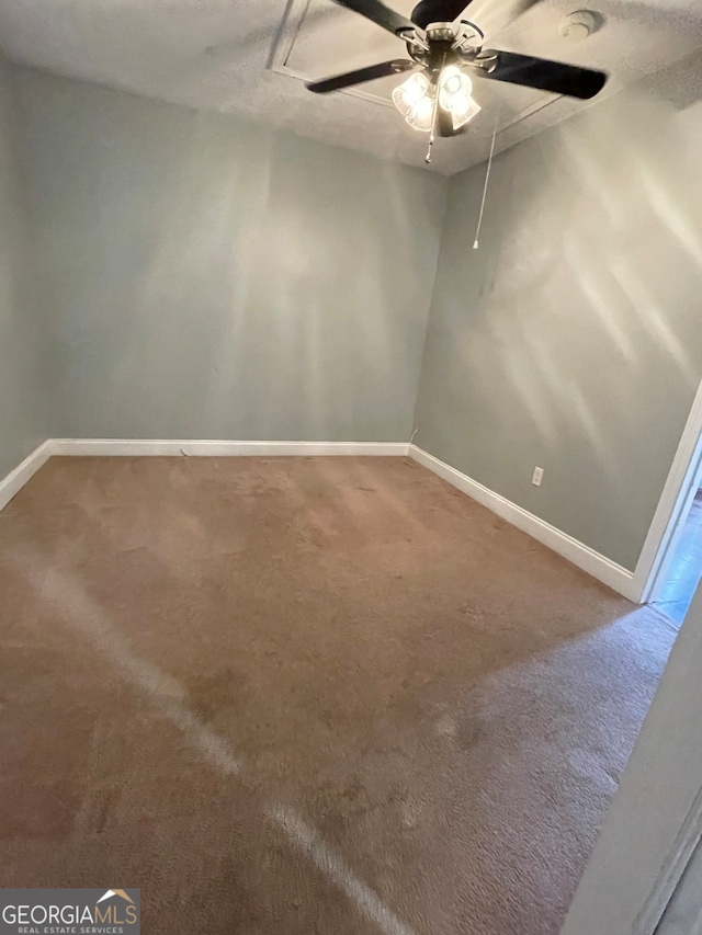 carpeted empty room featuring ceiling fan and a textured ceiling