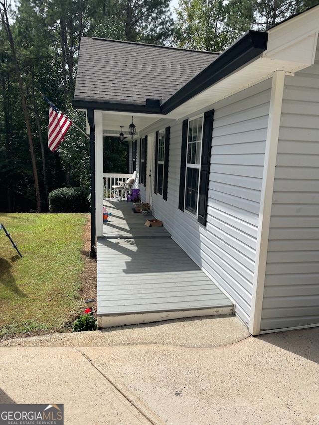 exterior space featuring a porch and a yard