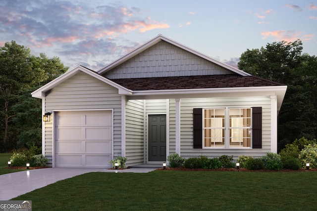 ranch-style house featuring a lawn, driveway, a garage, and roof with shingles