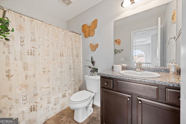 bathroom with vanity, toilet, curtained shower, and tile patterned floors