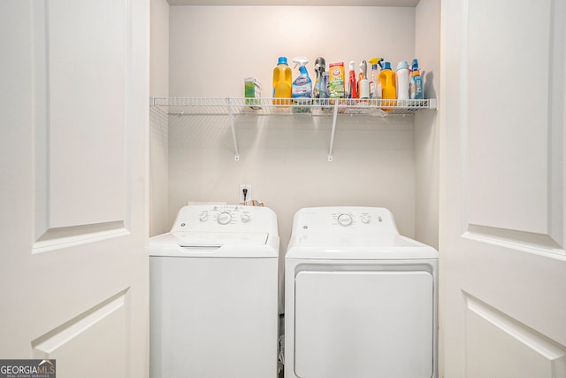 washroom with washing machine and clothes dryer