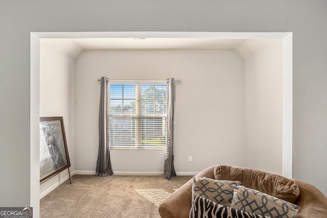 living area with light carpet and lofted ceiling