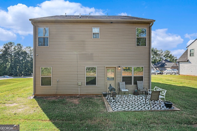 back of house featuring a lawn and a patio