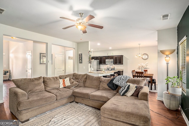 living room featuring ceiling fan and hardwood / wood-style flooring