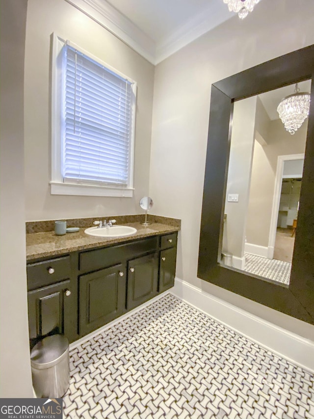 bathroom featuring ornamental molding, a chandelier, and vanity