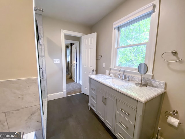 bathroom featuring a wealth of natural light, hardwood / wood-style flooring, and vanity