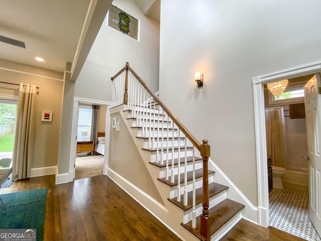 staircase featuring hardwood / wood-style flooring and a healthy amount of sunlight