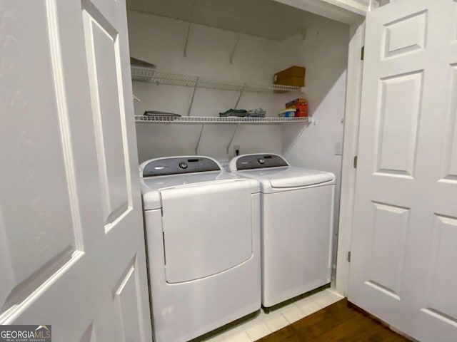 laundry room with hardwood / wood-style floors and independent washer and dryer