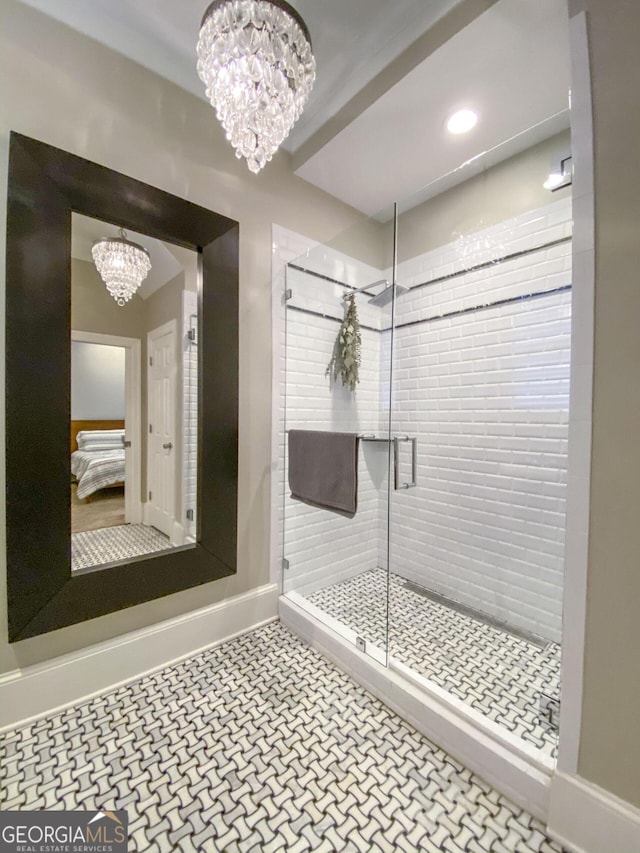 bathroom with an enclosed shower and a chandelier