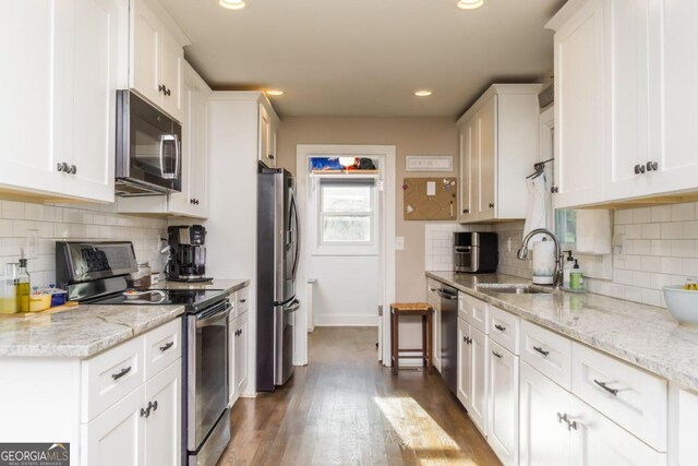 kitchen featuring dark hardwood / wood-style flooring, stainless steel appliances, sink, and white cabinets