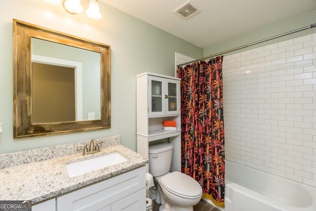 full bathroom with shower / bath combination with curtain, toilet, and vanity