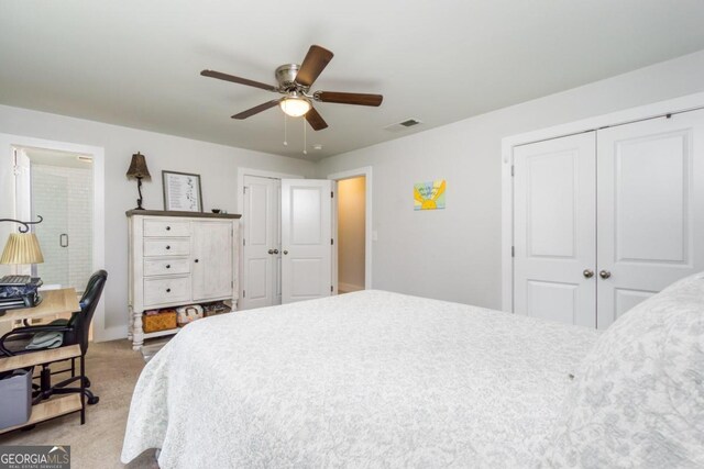 carpeted bedroom featuring two closets and ceiling fan