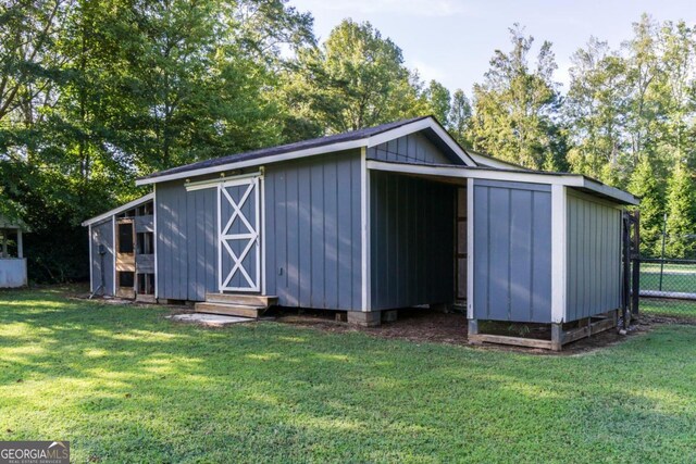 view of outbuilding featuring a yard