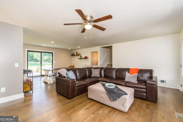 living room featuring ceiling fan and hardwood / wood-style flooring