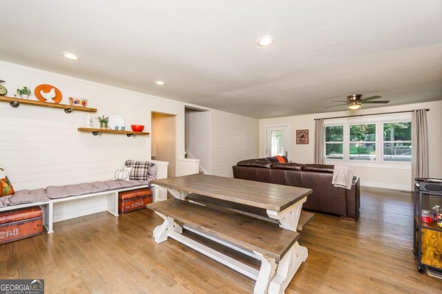 dining space featuring wood-type flooring and ceiling fan