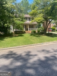 view of front facade with covered porch and a front yard