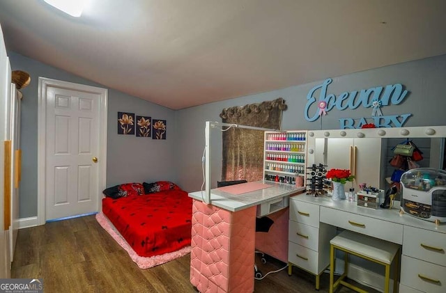 bedroom with vaulted ceiling and dark hardwood / wood-style flooring