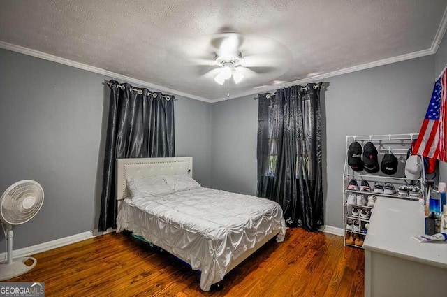 bedroom with ceiling fan, dark hardwood / wood-style flooring, and ornamental molding