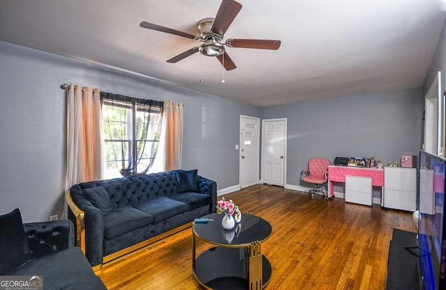 living room with ceiling fan and dark hardwood / wood-style flooring