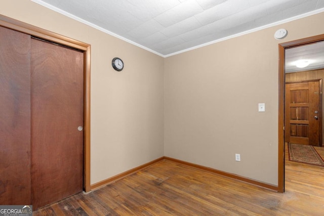 interior space featuring crown molding and hardwood / wood-style flooring