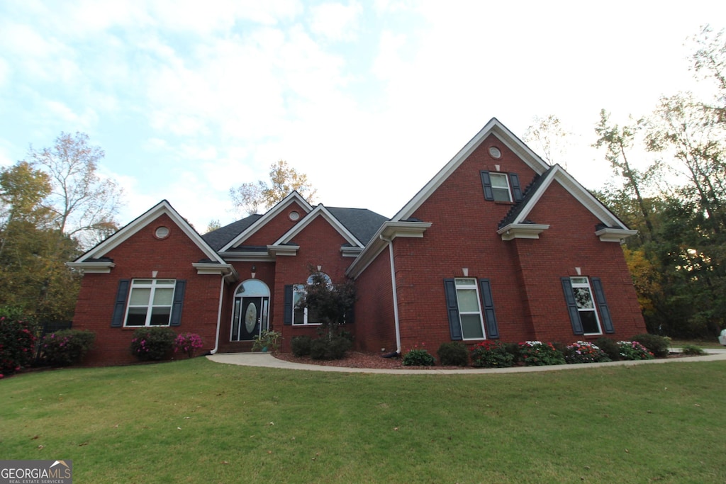 view of property featuring a front lawn