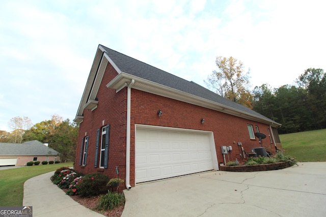 view of side of home with central AC and a garage