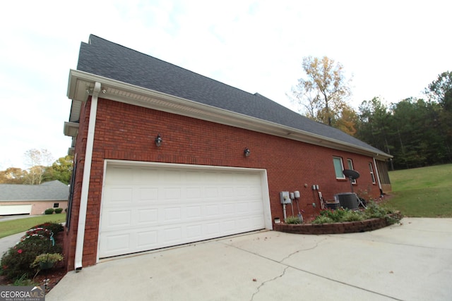 view of side of home with cooling unit and a garage