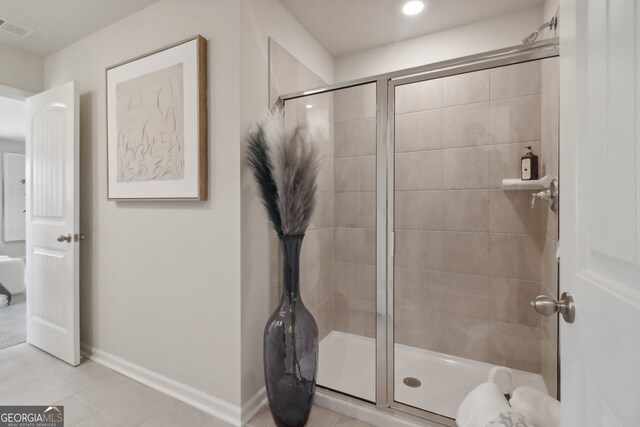 bathroom featuring tile patterned floors and an enclosed shower