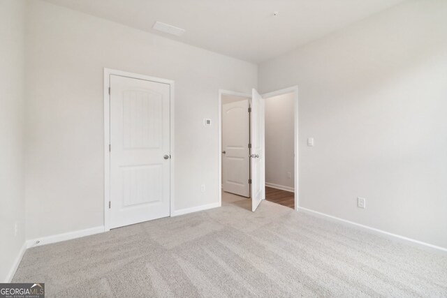 unfurnished bedroom with light carpet