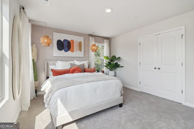 carpeted bedroom featuring a closet