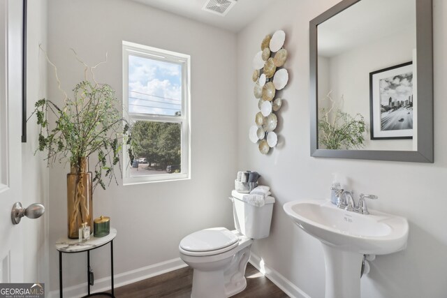 bathroom featuring hardwood / wood-style flooring and toilet