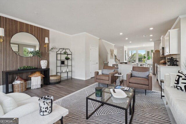 living room featuring crown molding, a healthy amount of sunlight, and dark hardwood / wood-style floors