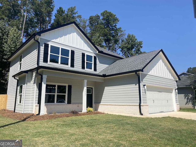 view of front of property with a garage, brick siding, board and batten siding, and a front yard