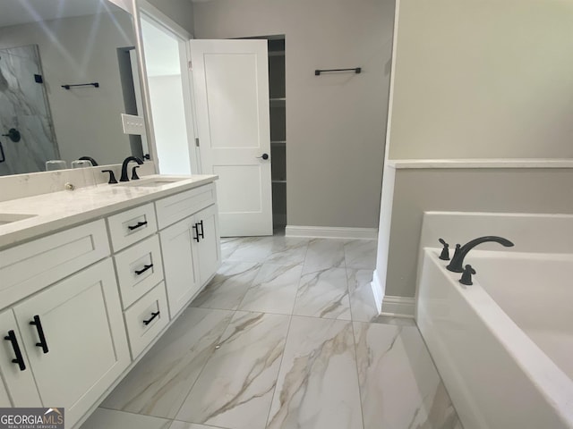 bathroom featuring double vanity, baseboards, marble finish floor, a garden tub, and a sink