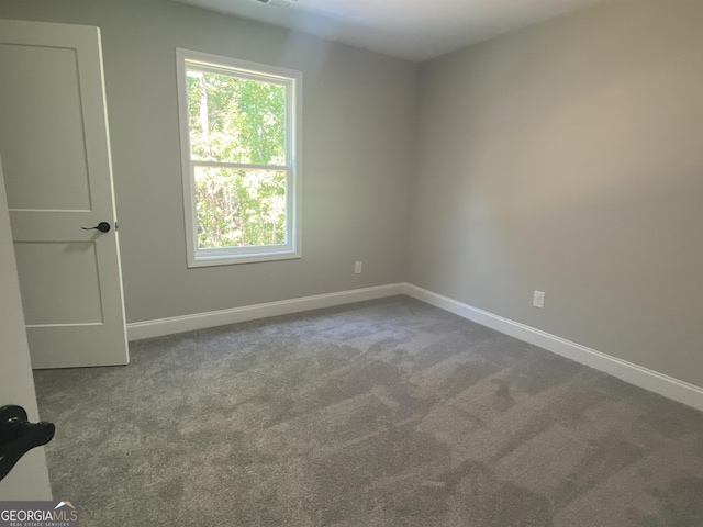 carpeted empty room with baseboards